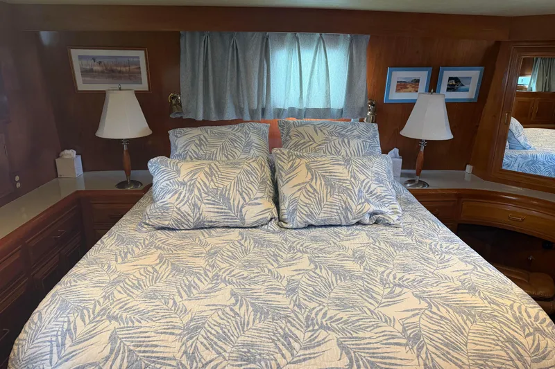  Yacht Photos Pics Cozy bedroom in 1988 Ocean Alexander 42' yacht with patterned bedding and elegant decor.