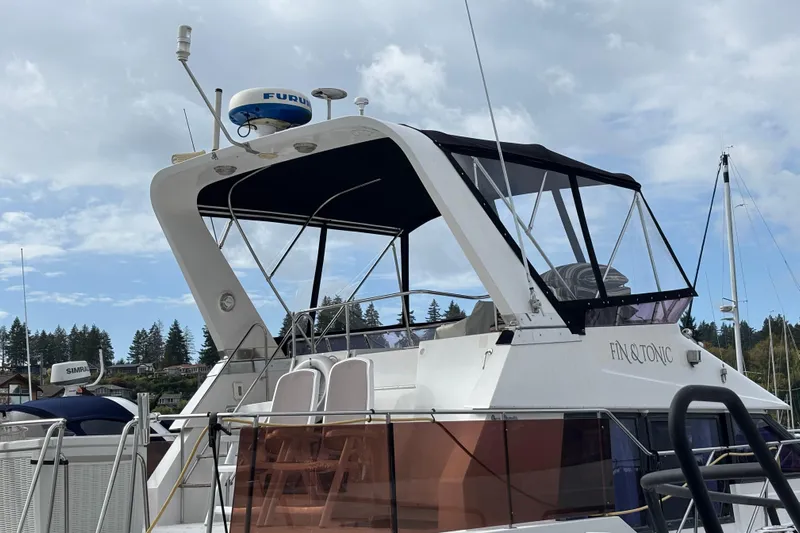  Yacht Photos Pics 1988 Ocean Alexander 42' yacht docked, featuring a black canopy and radar equipment.