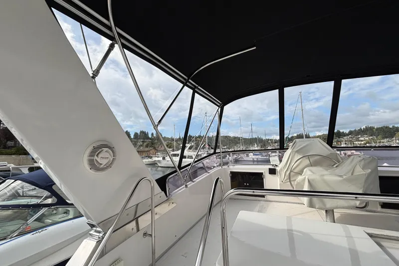  Yacht Photos Pics 1988 Ocean Alexander 42' yacht interior with covered seating and marina view.