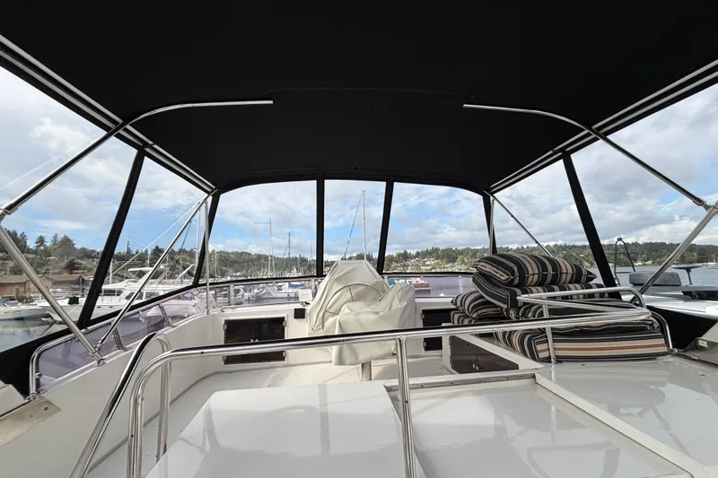  Yacht Photos Pics Interior view of 1988 Ocean Alexander 42' yacht with striped cushions and marina backdrop.