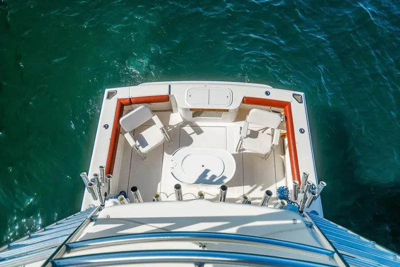 Gyro Stabilized Yacht Photos Pics Aerial view of 2005 Cabo 35 Express boat deck on clear blue water.