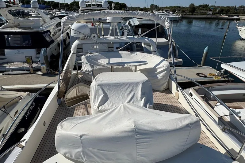  Yacht Photos Pics Luxury 2006 Aicon 56 yacht docked at marina, covered seating area.