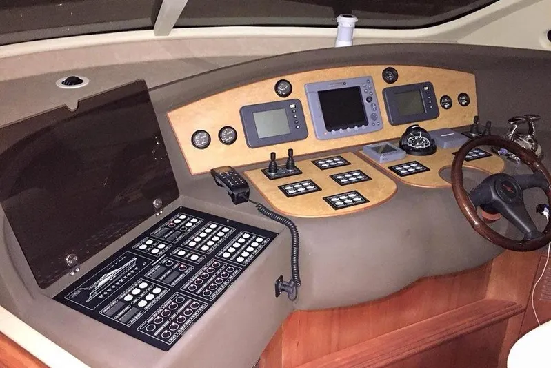  Yacht Photos Pics Control panel of a 2006 Aicon 56 yacht with navigation instruments and steering wheel.
