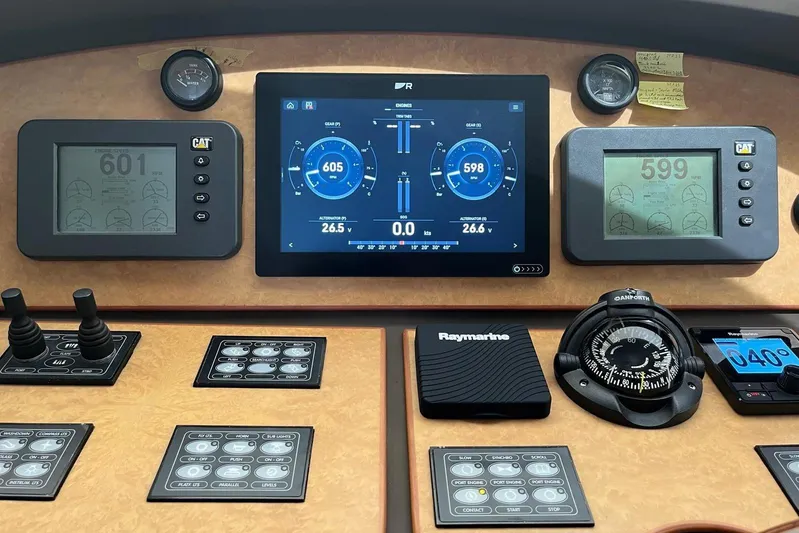  Yacht Photos Pics Control panel of a 2006 Aicon 56 yacht with navigation and engine displays.