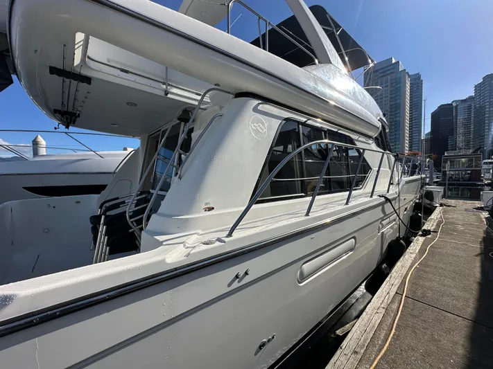 Solana Yacht Photos Pics 2000 Bayliner 5288 Pilot House Motoryacht docked at marina, city skyline in background.