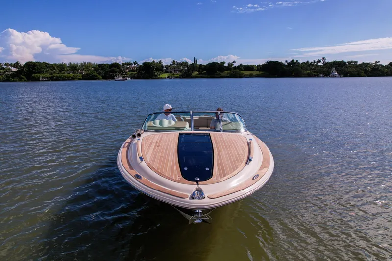  Yacht Photos Pics 2017 Chris-Craft Corsair 28 Heritage Edition on serene lake under clear blue sky.