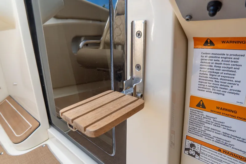  Yacht Photos Pics 2017 Chris-Craft Corsair 28 Heritage Edition interior with safety warnings and wooden step detail.