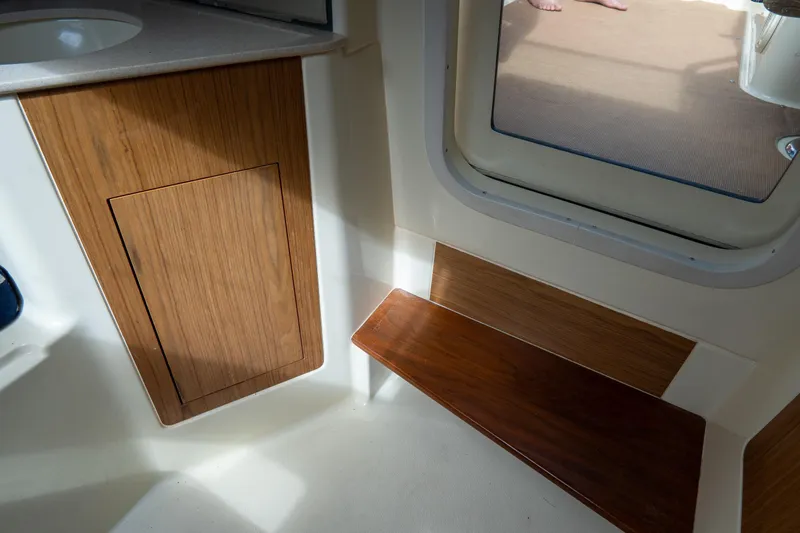  Yacht Photos Pics 2017 Chris-Craft Corsair 28 Heritage Edition interior with wooden cabinetry and seating.