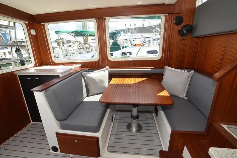San Juan Explorer Yacht Photos Pics Interior of 2020 American Tug 362 with cozy seating and wooden table.