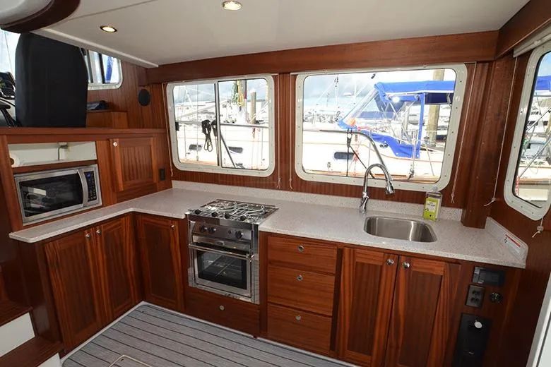 San Juan Explorer Yacht Photos Pics Modern kitchen interior of 2020 American Tug 362 yacht with wood cabinetry and appliances.