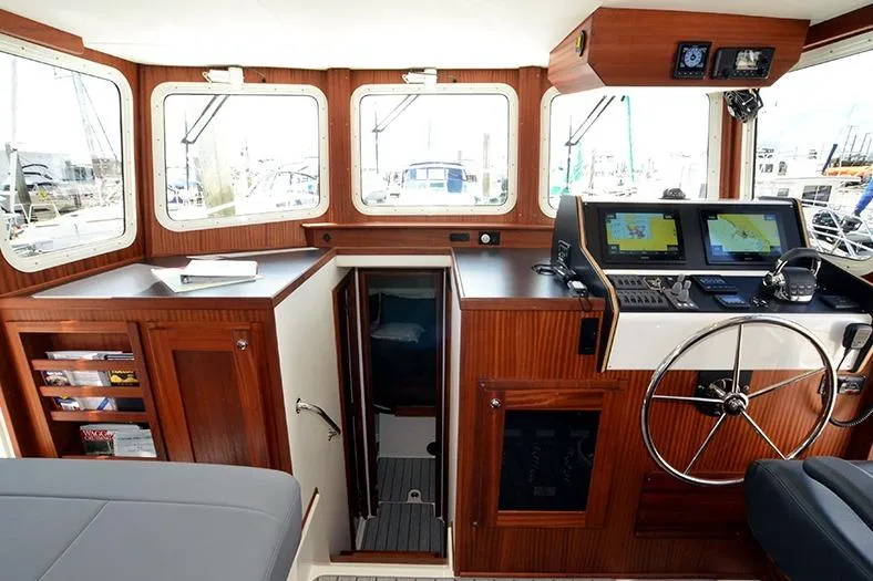 San Juan Explorer Yacht Photos Pics Interior of 2020 American Tug 362 with navigation equipment and wooden cabinetry.