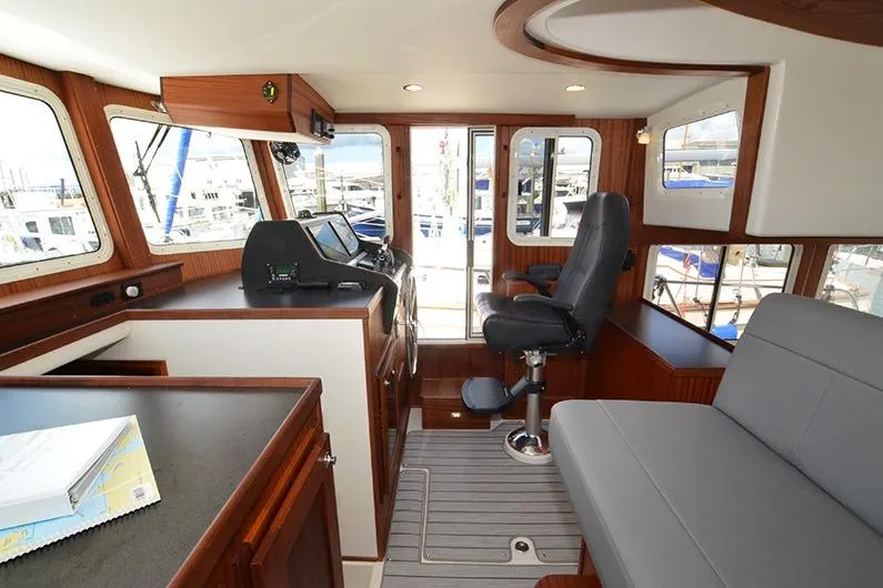 San Juan Explorer Yacht Photos Pics Interior of 2020 American Tug 362, featuring helm station and seating area.