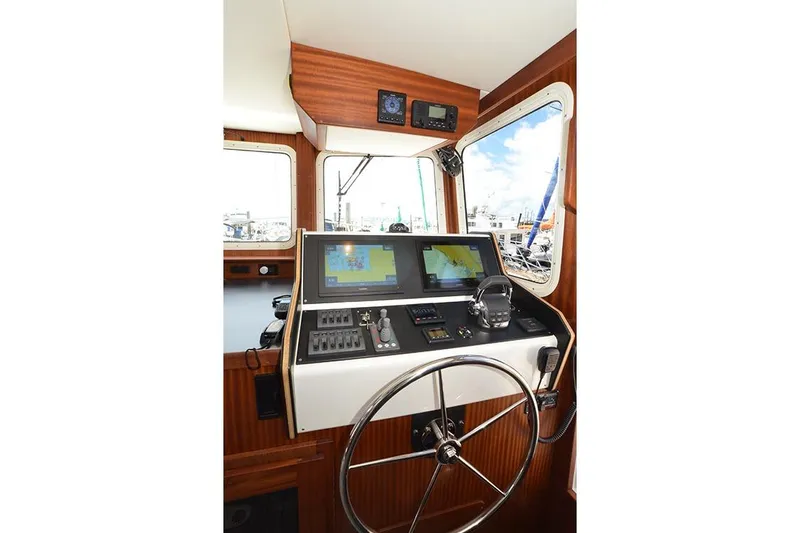 San Juan Explorer Yacht Photos Pics 2020 American Tug 362 helm with navigation screens and steering wheel.
