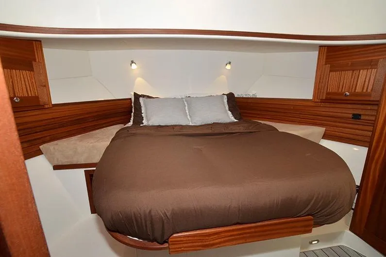 San Juan Explorer Yacht Photos Pics Cozy bedroom in 2020 American Tug 362 with wood accents and ambient lighting.