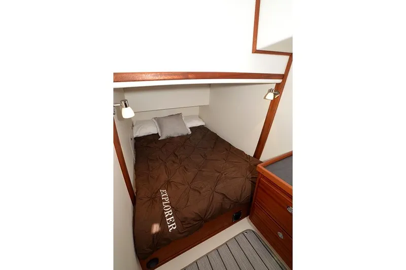 San Juan Explorer Yacht Photos Pics Cozy cabin interior of 2020 American Tug 362 with brown bedding and wooden accents.