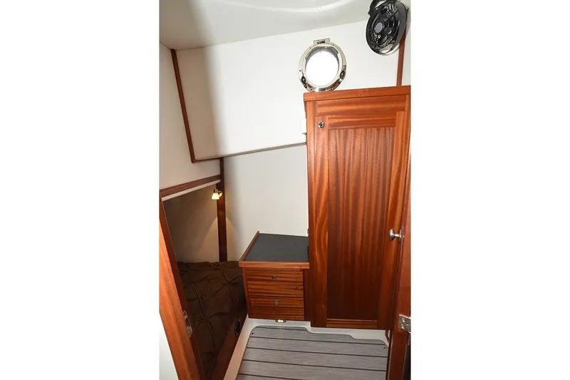 San Juan Explorer Yacht Photos Pics Interior of 2020 American Tug 362, featuring wooden cabinetry and a porthole window.
