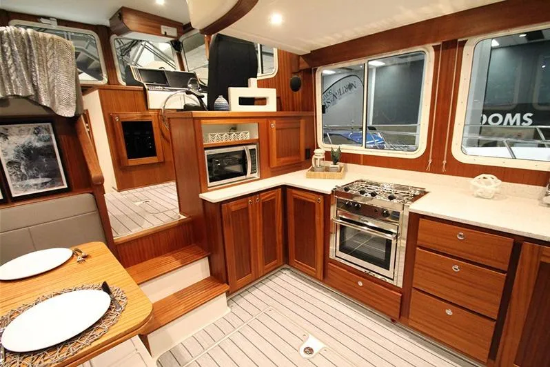 San Juan Explorer Yacht Photos Pics Interior of a 2020 American Tug 362, featuring a modern kitchen and dining area.