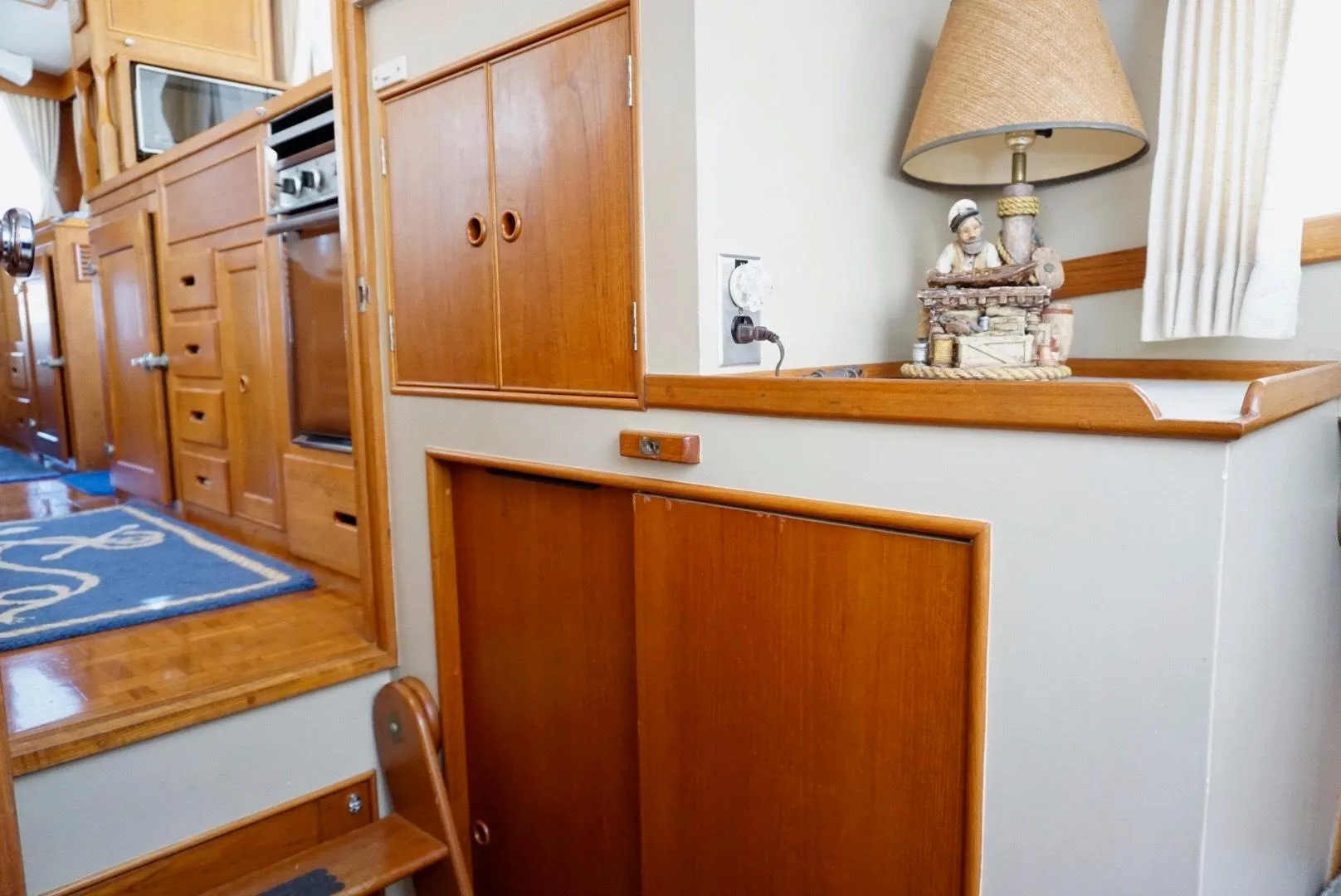 Interior of 1982 Grand Banks Classic yacht with wooden cabinetry and nautical decor.