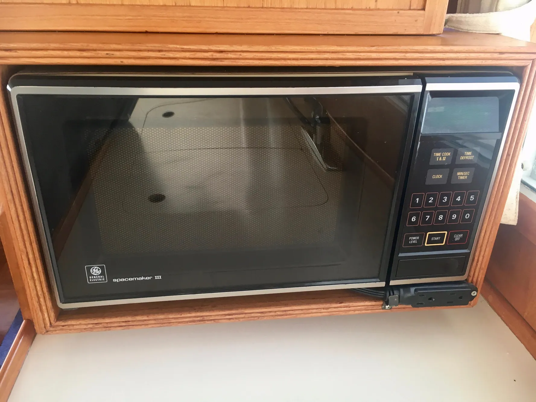 1982 Grand Banks Classic microwave in wooden kitchen setting.