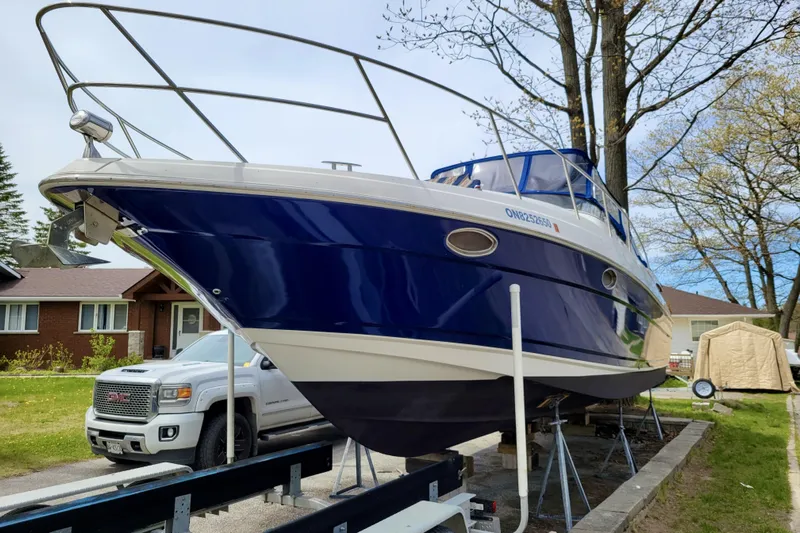  Yacht Photos Pics 2005 Regal Commodore 3560 boat on trailer, parked near residential area.