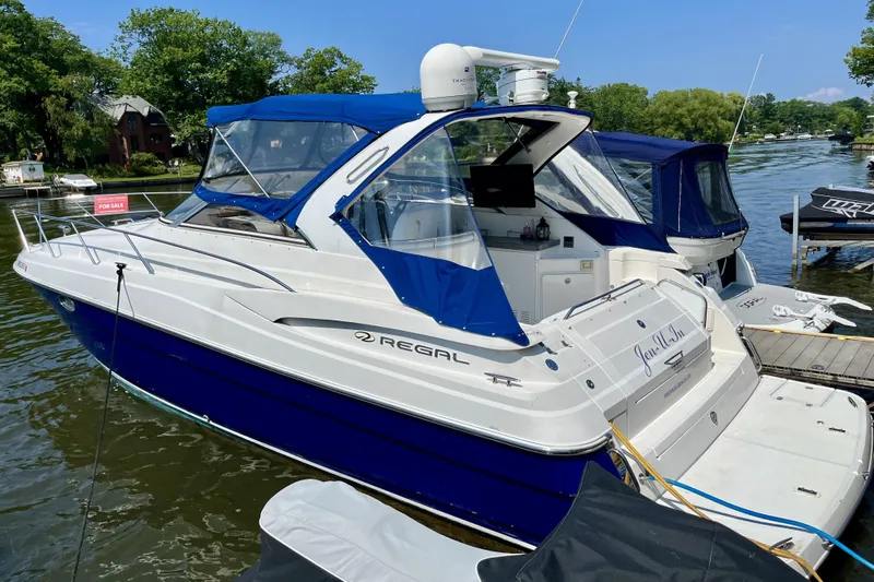 Yacht Photos Pics 2005 Regal Commodore 3560 yacht docked, featuring blue and white design, for sale.