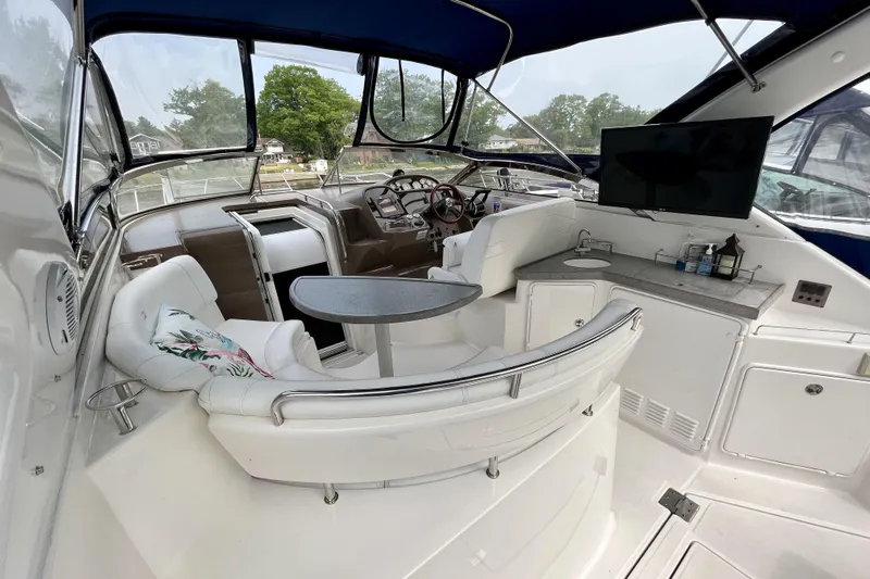  Yacht Photos Pics 2005 Regal Commodore 3560 yacht interior with seating, table, and helm station.