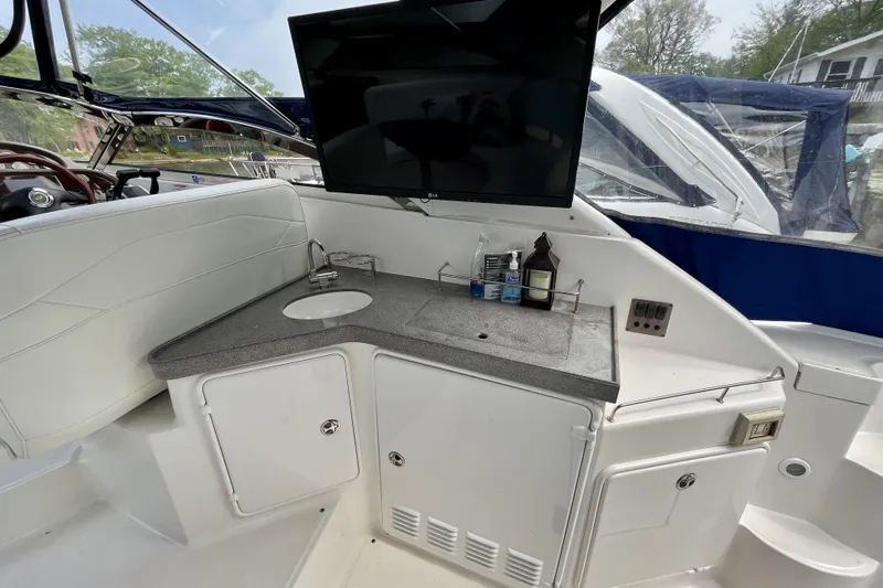  Yacht Photos Pics 2005 Regal Commodore 3560 yacht interior with sink, countertop, and mounted TV.