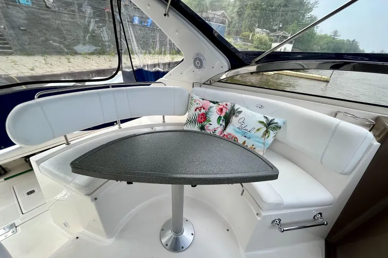  Yacht Photos Pics Interior of 2005 Regal Commodore 3560 yacht with white seating and decorative pillows.