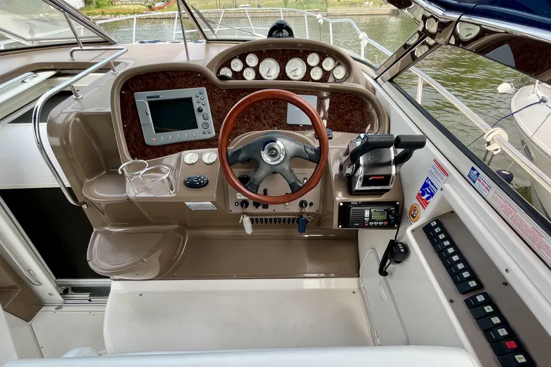  Yacht Photos Pics Cockpit of 2005 Regal Commodore 3560 boat with steering wheel and navigation controls.