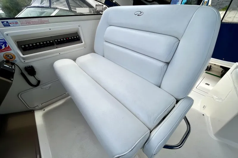  Yacht Photos Pics 2005 Regal Commodore 3560 boat interior with white cushioned seating and control panel.