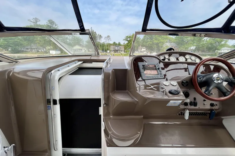  Yacht Photos Pics 2005 Regal Commodore 3560 boat cockpit with steering wheel and control panel.