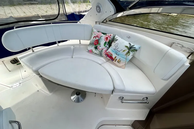  Yacht Photos Pics 2005 Regal Commodore 3560 boat interior with white seating and decorative pillows.