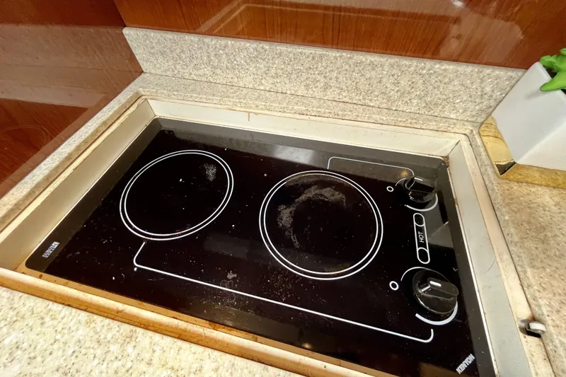  Yacht Photos Pics Built-in stovetop on 2005 Regal Commodore 3560 yacht, featuring dual burners and sleek design.