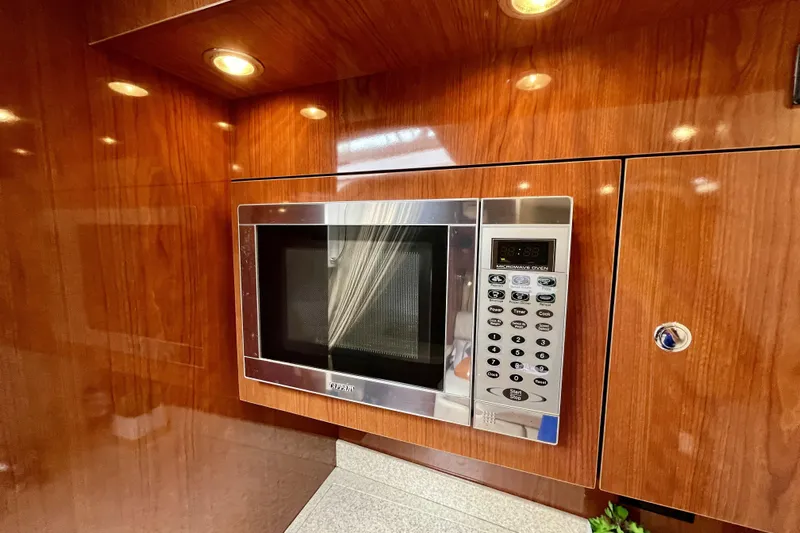  Yacht Photos Pics Built-in microwave in 2005 Regal Commodore 3560 yacht's wooden interior kitchen.