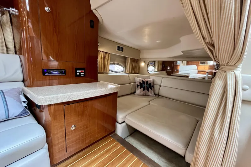  Yacht Photos Pics Luxurious interior of 2005 Regal Commodore 3560 yacht with plush seating and wood accents.