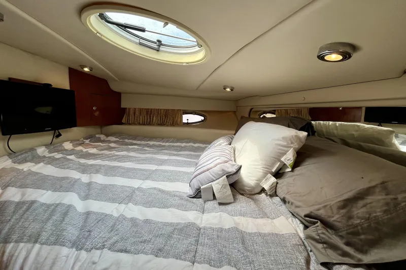  Yacht Photos Pics Cozy cabin interior of 2005 Regal Commodore 3560 yacht with bed and porthole.