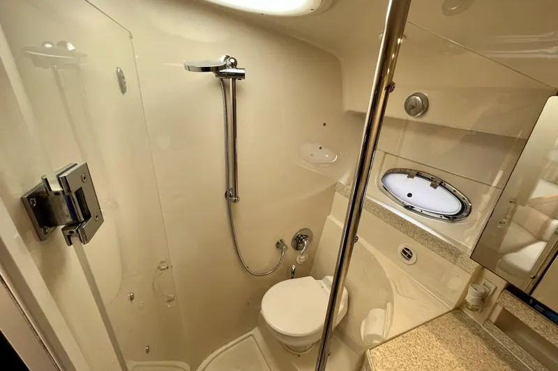  Yacht Photos Pics 2005 Regal Commodore 3560 yacht bathroom with shower, toilet, and porthole window.