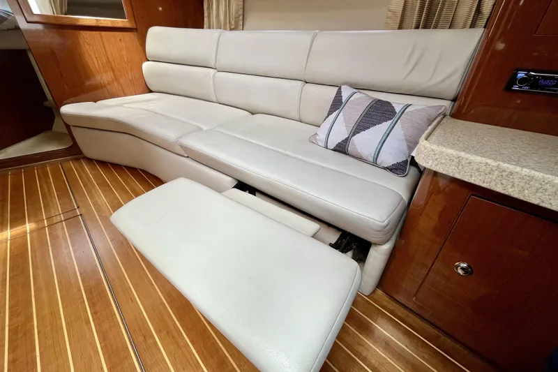  Yacht Photos Pics Luxurious interior of 2005 Regal Commodore 3560 yacht with plush seating and wooden flooring.