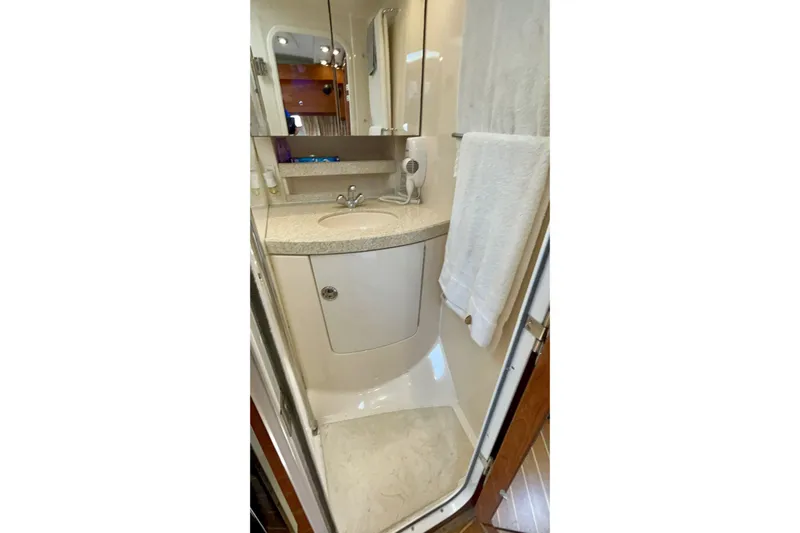  Yacht Photos Pics 2005 Regal Commodore 3560 yacht bathroom with sink, mirror, and towel.
