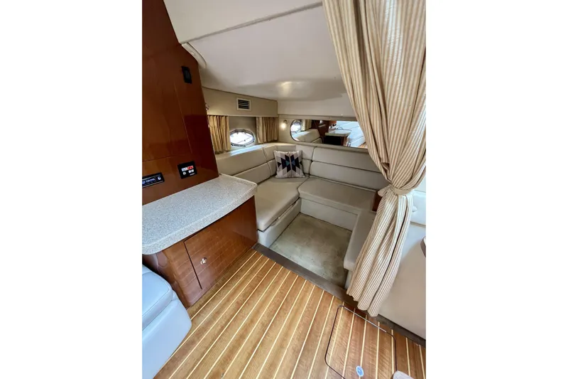  Yacht Photos Pics Luxurious interior of 2005 Regal Commodore 3560 yacht with cozy seating and elegant wood finishes.