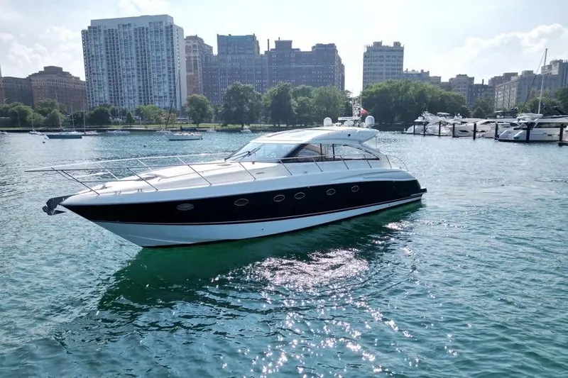  Yacht Photos Pics 2008 Princess V53 yacht cruising in a city harbor with skyline backdrop.