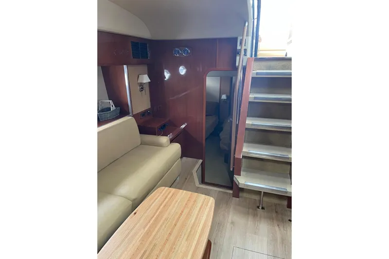  Yacht Photos Pics Interior of 2008 Princess V53 yacht with beige seating and wooden accents.