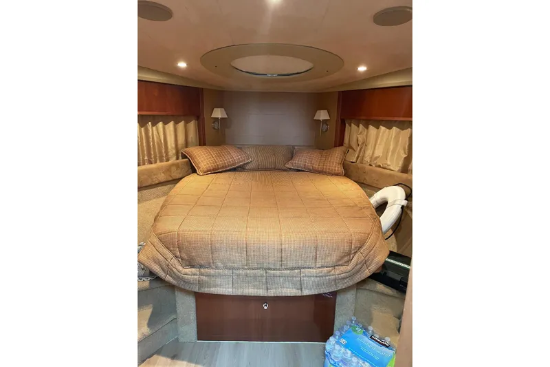  Yacht Photos Pics Luxurious cabin interior of 2008 Princess V53 yacht with cozy bed and elegant decor.