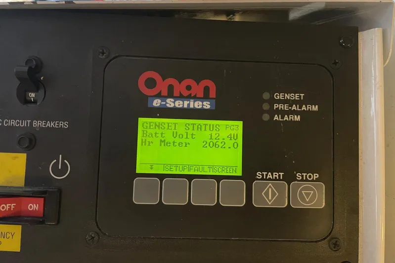  Yacht Photos Pics Onan e-Series generator control panel displaying battery voltage and hour meter readings.