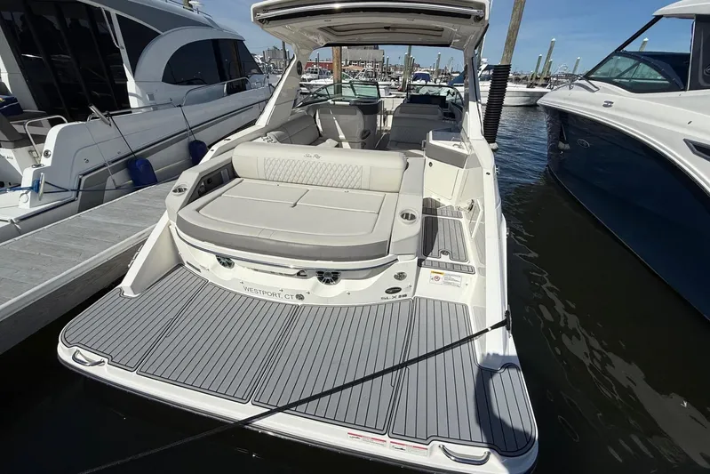  Yacht Photos Pics 2021 Sea Ray SLX 310 boat docked, featuring spacious seating and sleek design.