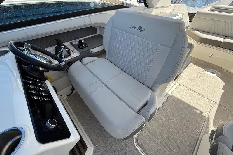  Yacht Photos Pics 2021 Sea Ray SLX 310 boat interior with steering wheel and plush seating.