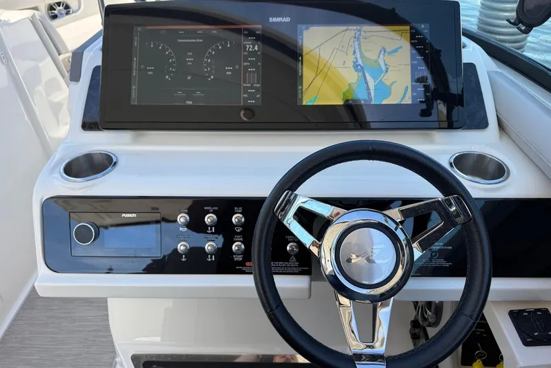  Yacht Photos Pics 2021 Sea Ray SLX 310 helm with navigation display and steering wheel.