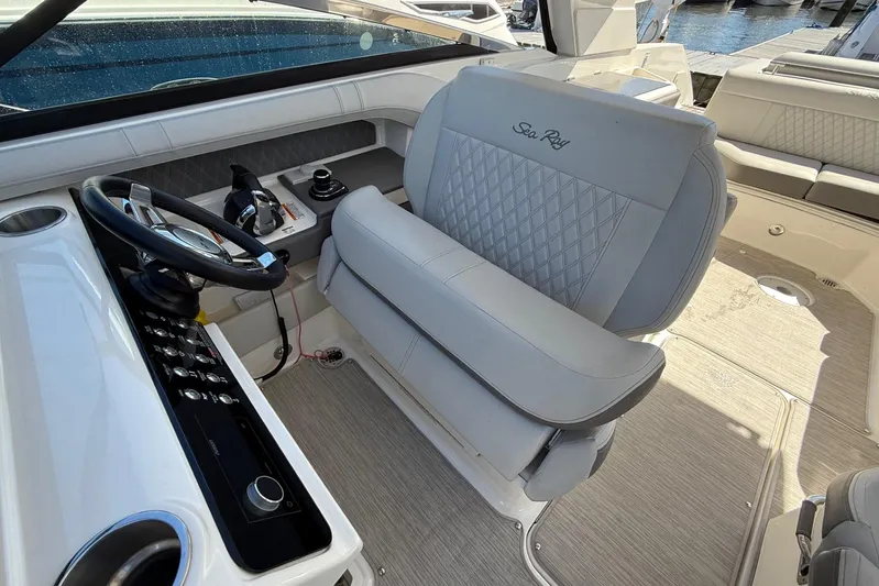  Yacht Photos Pics 2021 Sea Ray SLX 310 boat interior with steering wheel and luxurious seating.