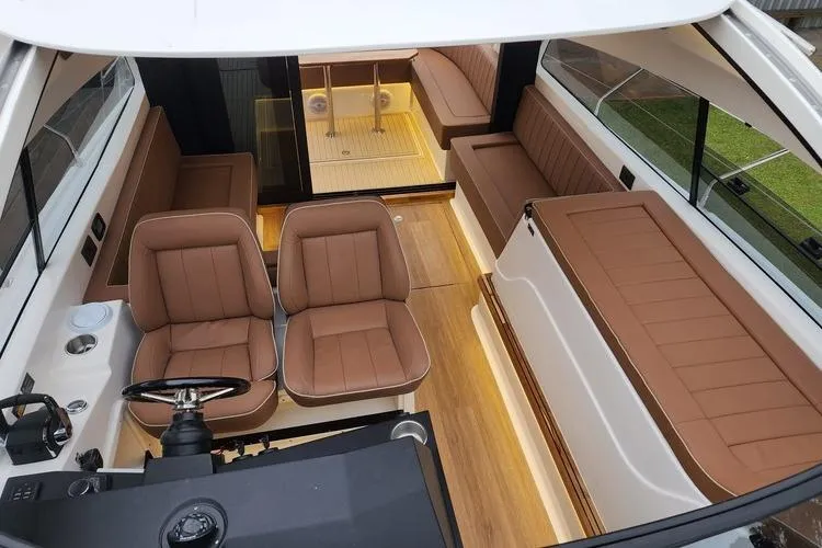 Custom Order Your 415 Today! Yacht Photos Pics Luxurious 2026 Hanover 415 Inboard boat interior with brown leather seating and modern design.