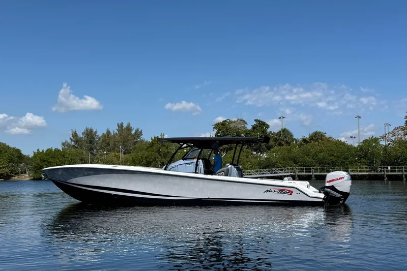  Yacht Photos Pics 2018 Nor-Tech 390 Sport Center Console boat on calm water under blue sky.